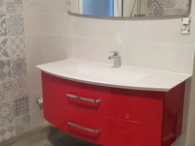 Salle de bain avec meuble vasque rouge et lave-linge